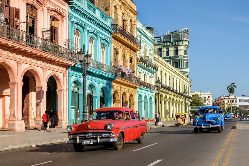 HAVANA,CUBA - MAY 26,2016 : Street scene with colorful buildings and old american car in downtown Havana